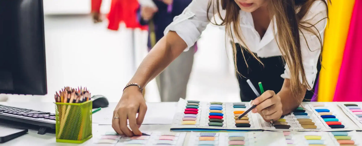 Fashion designer selecting fabric swatches.