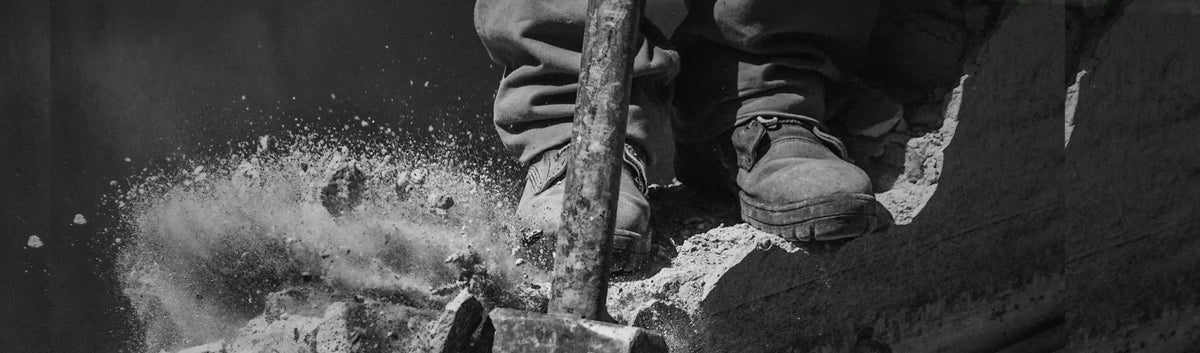 Construction worker with jackhammer in premium quality waders for tough outdoor work